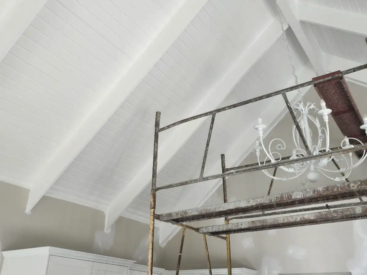 High painted timber ceiling with exposed trusses and scaffolding during interior preparation at a Welgemoed home in Bellville
