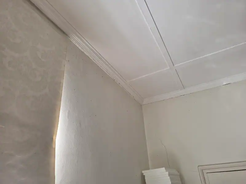Loose cornice and wall cracking before interior repairs at a Bishopscourt Village home