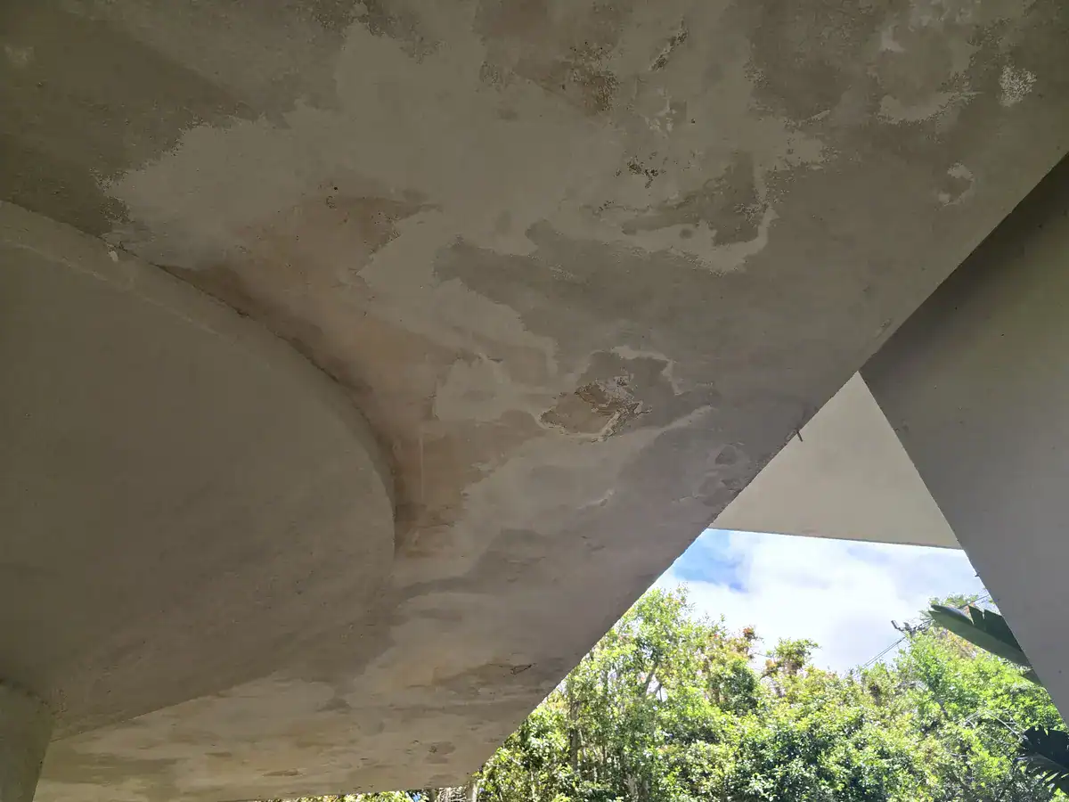 Moisture staining and deteriorated coating below a swimming-pool deck before repairs at a Moreson Estate home in Brackenfell