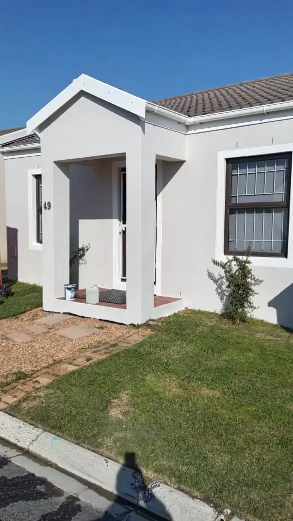 Completed exterior walls after damp-related repairs and painting at a private home in Claremont