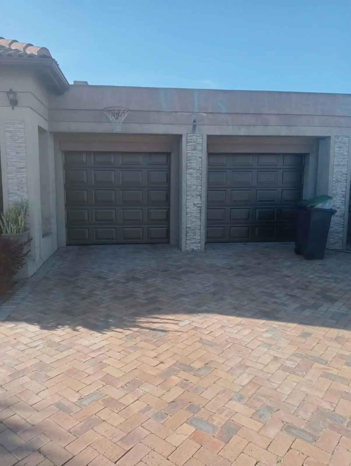 Garage and exterior walls being prepared before painting at Fernwood Estate in Newlands