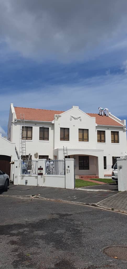 Exterior wall preparation and repaired areas on a double-storey home in Mellow Wood Estate, Constantia