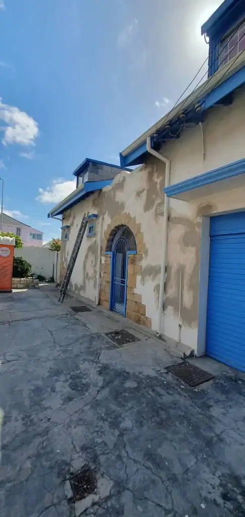 Older Muizenberg Village home during exterior wall preparation before coastal repainting