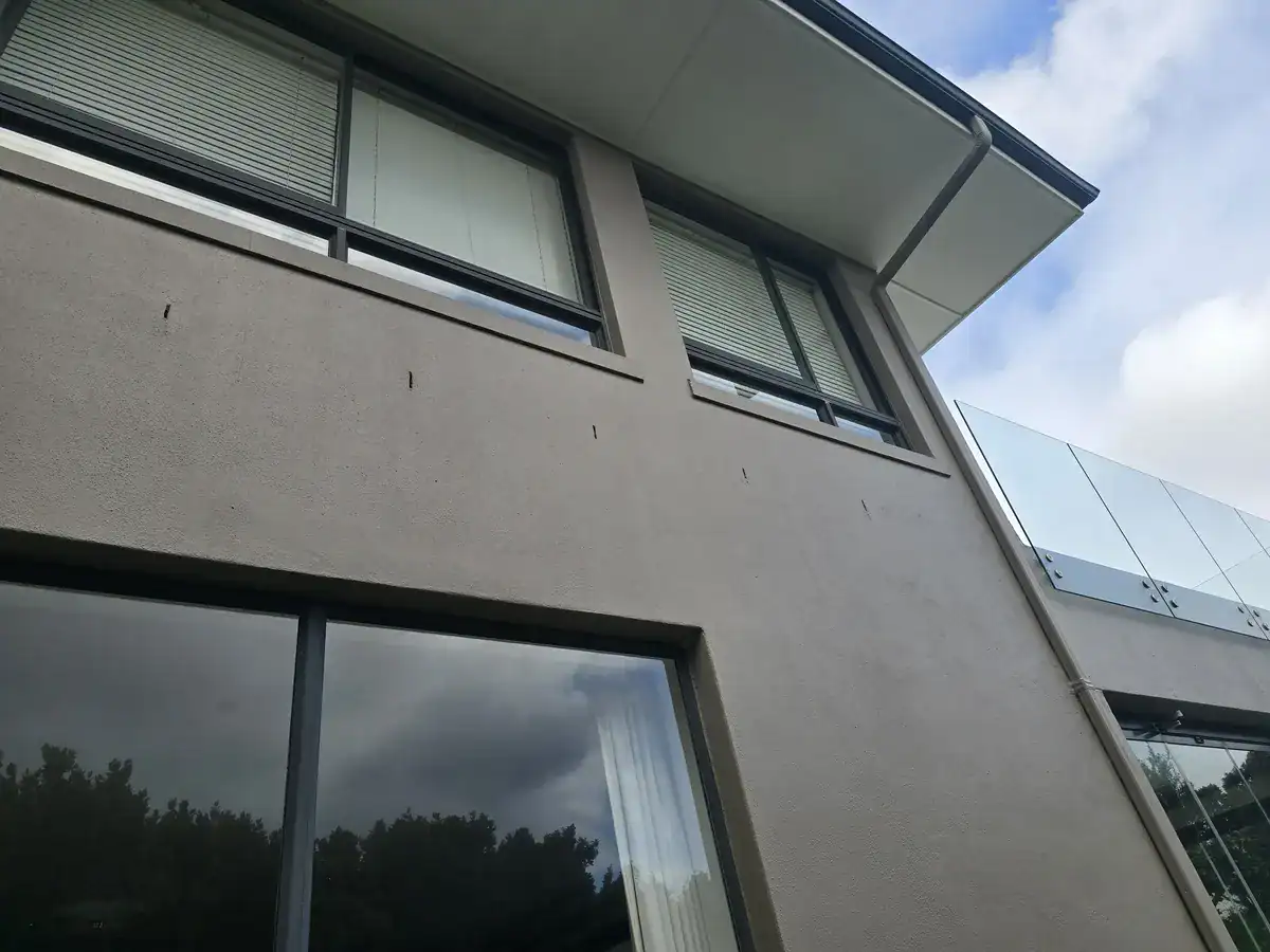 Completed exterior wall, windows and soffits after crack repairs and painting at a Baronetcy Estate home in Plattekloof