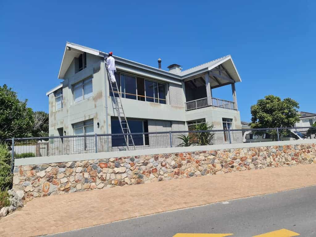 Painter preparing the exterior walls and fascia of a double-storey home in Silverhurst Estate, Constantia