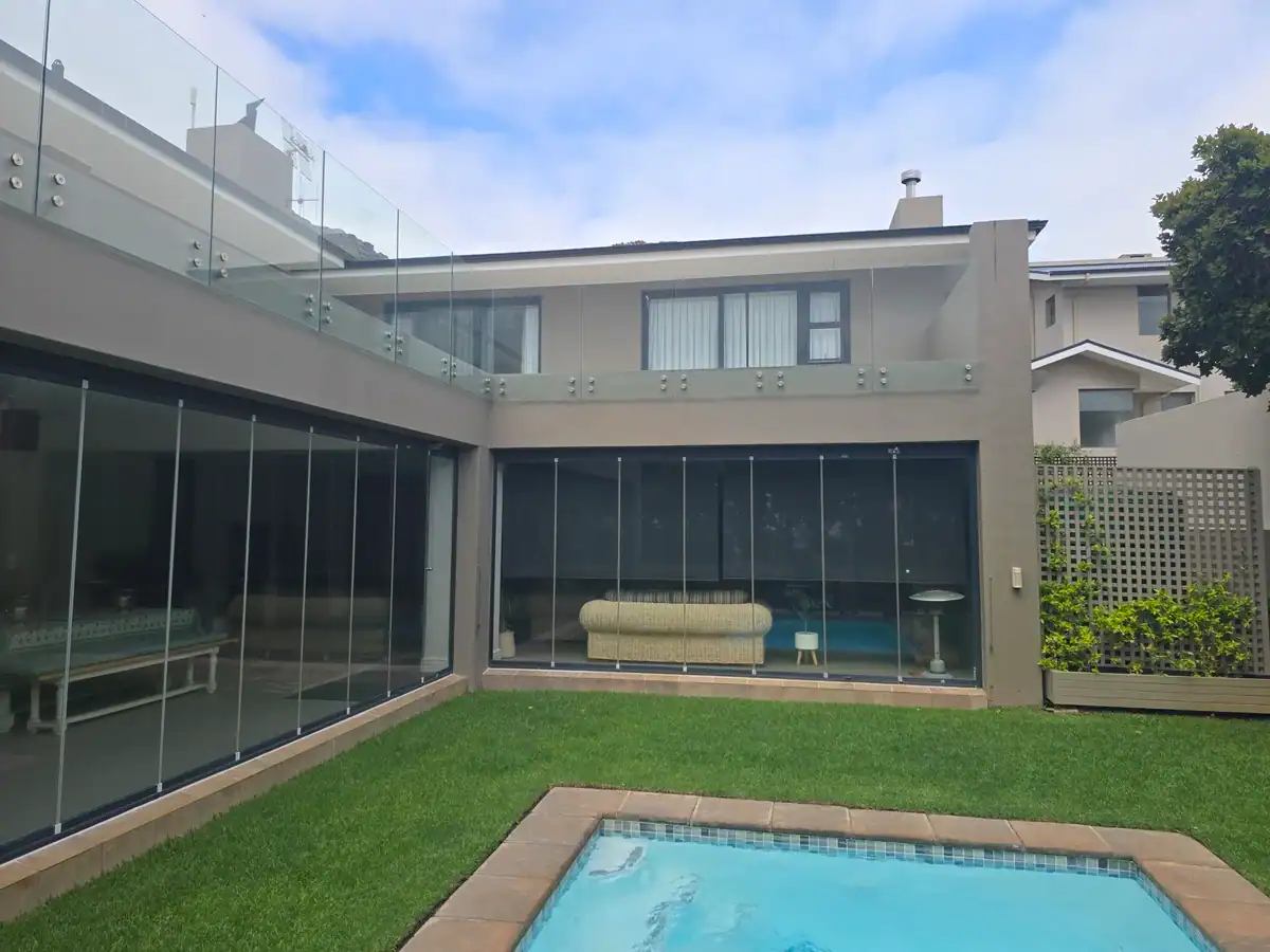 Completed exterior walls after moisture repairs and painting at a Steenberg Golf Estate home in Tokai