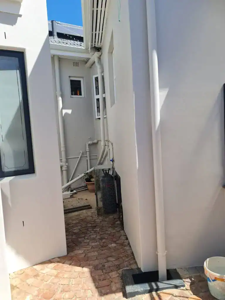 Completed exterior walls at a Tamboerskloof heritage home after damp-related preparation and repainting