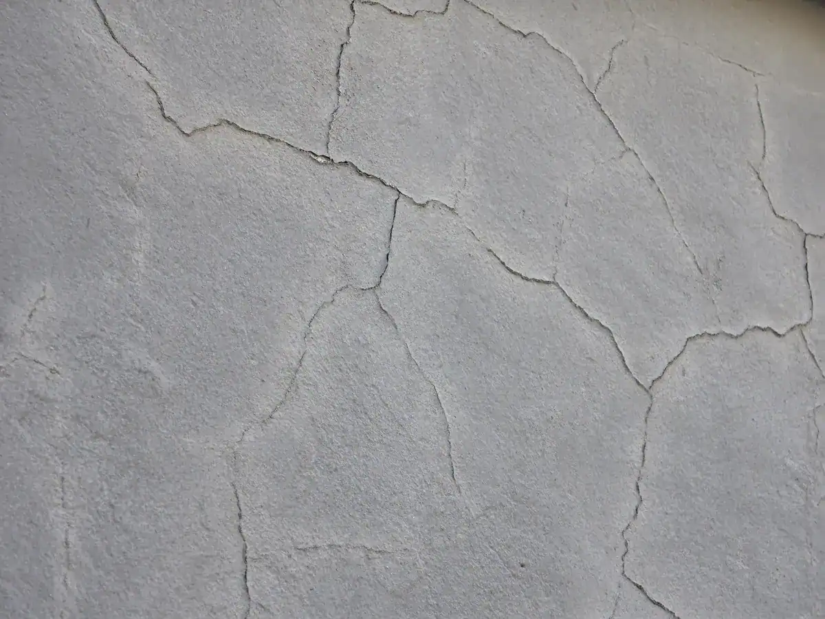 Cracked and poorly bonded exterior coating before preparation at a private Kuils River home