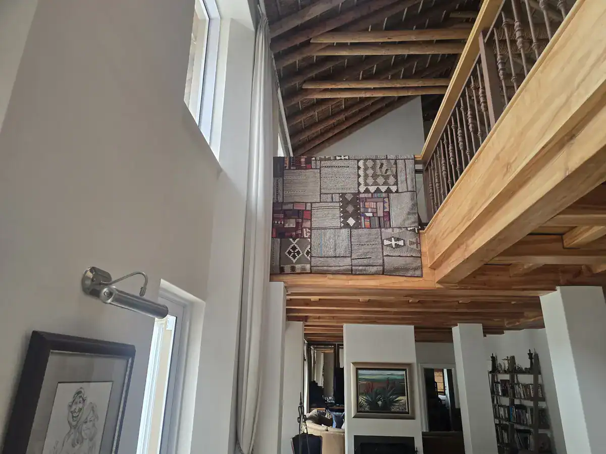 Completed double-volume interior with repainted walls and natural timber finishes at an Erinvale Estate home in Somerset West