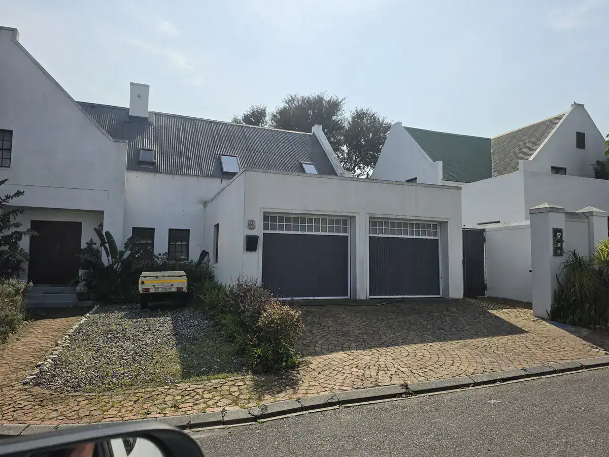 Weathered exterior walls and corrugated roof before painting at a Lemoenkloof home in Paarl