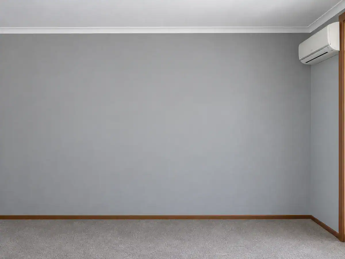 Repainted light-grey bedroom wall with white cornice and timber skirting in Aurora, Durbanville.