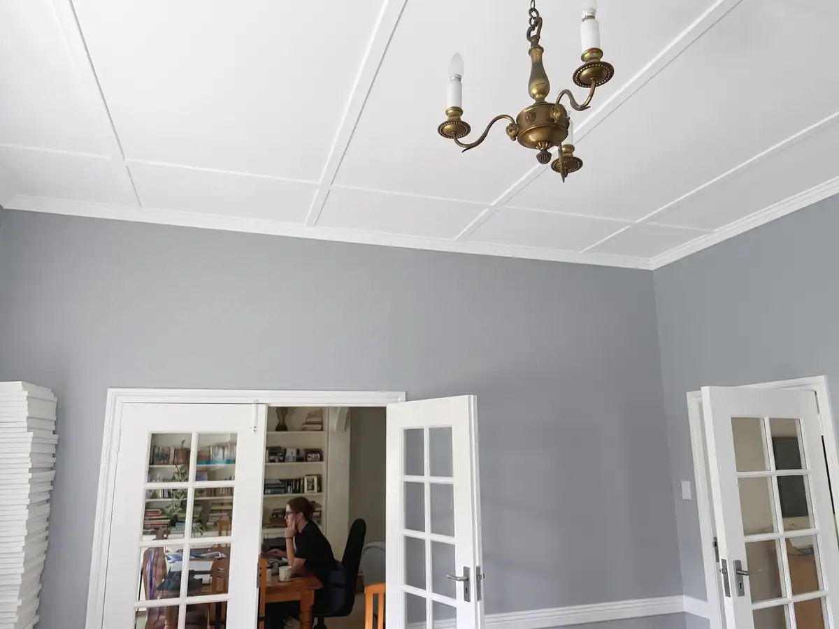Completed interior painting with grey walls and white decorative ceiling at a residential property in Gardens, Cape Town