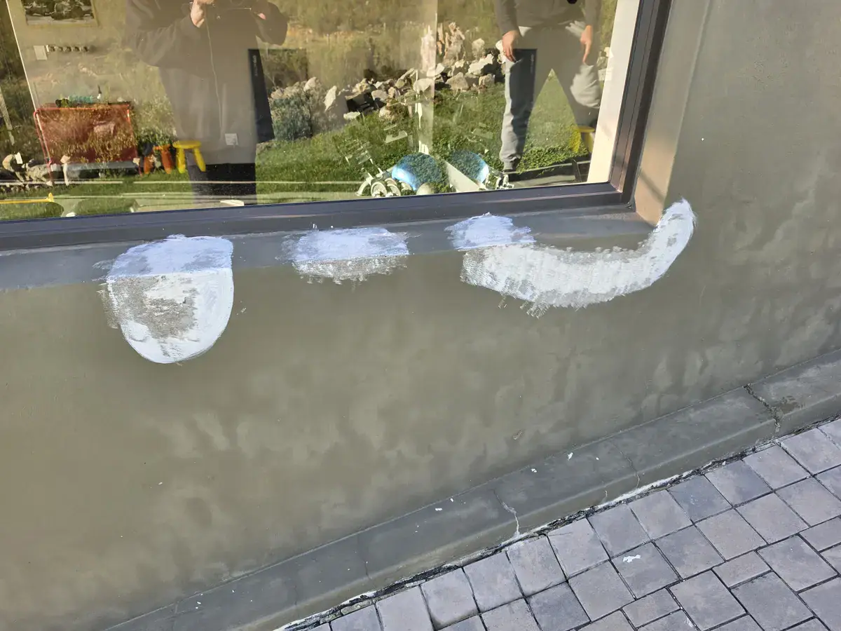 Moisture discolouration and repaired areas below window before repainting at Nuutgevonden Estate Stellenbosch