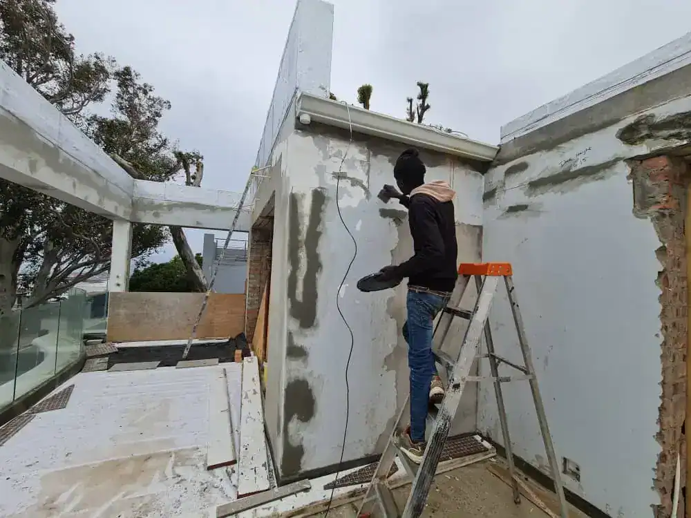 Exterior wall preparation and crack repairs during a painting project in Upper Vredehoek, Cape Town